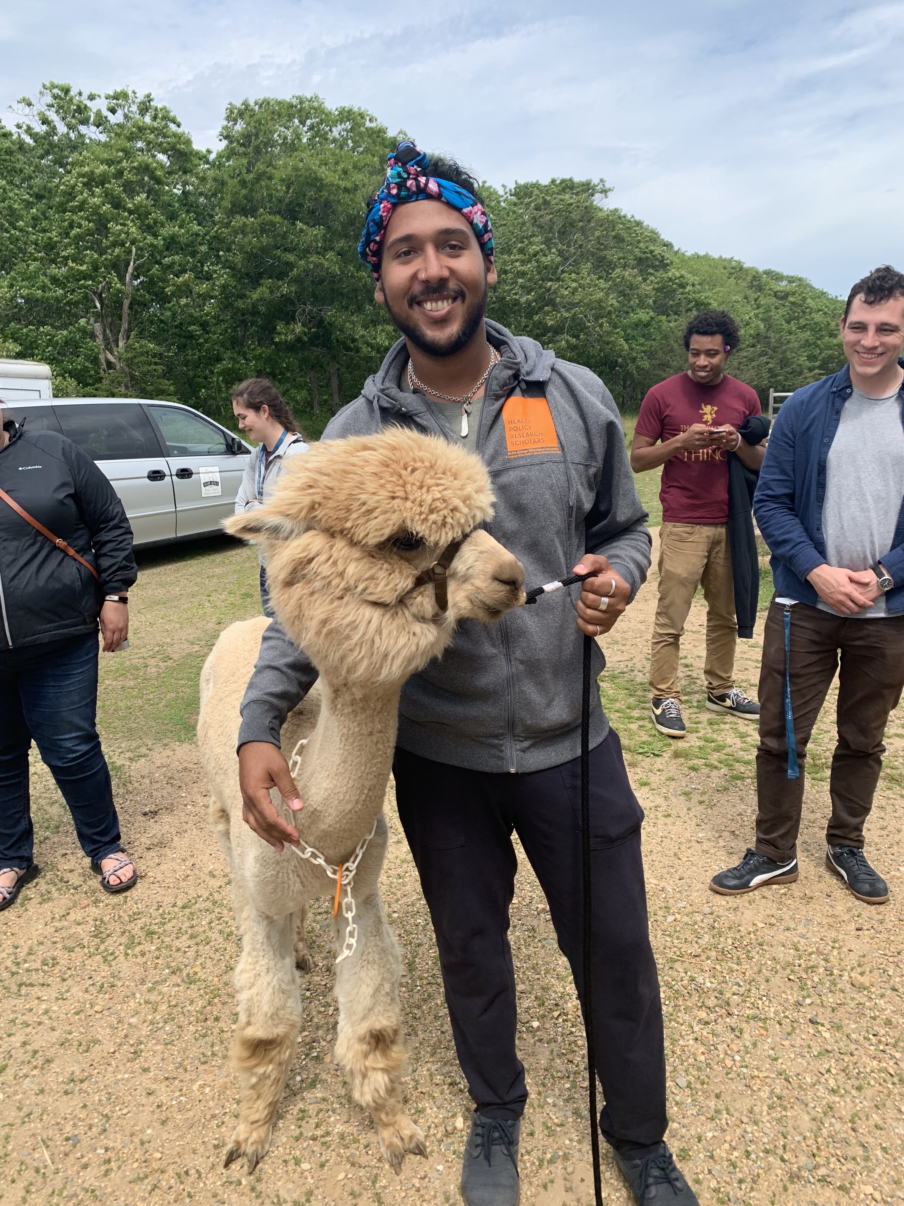Michael standing next to a alpaca